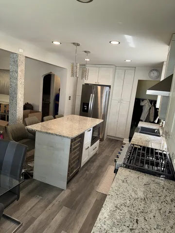 a large bedroom with a bed and a large mirror on the dresser