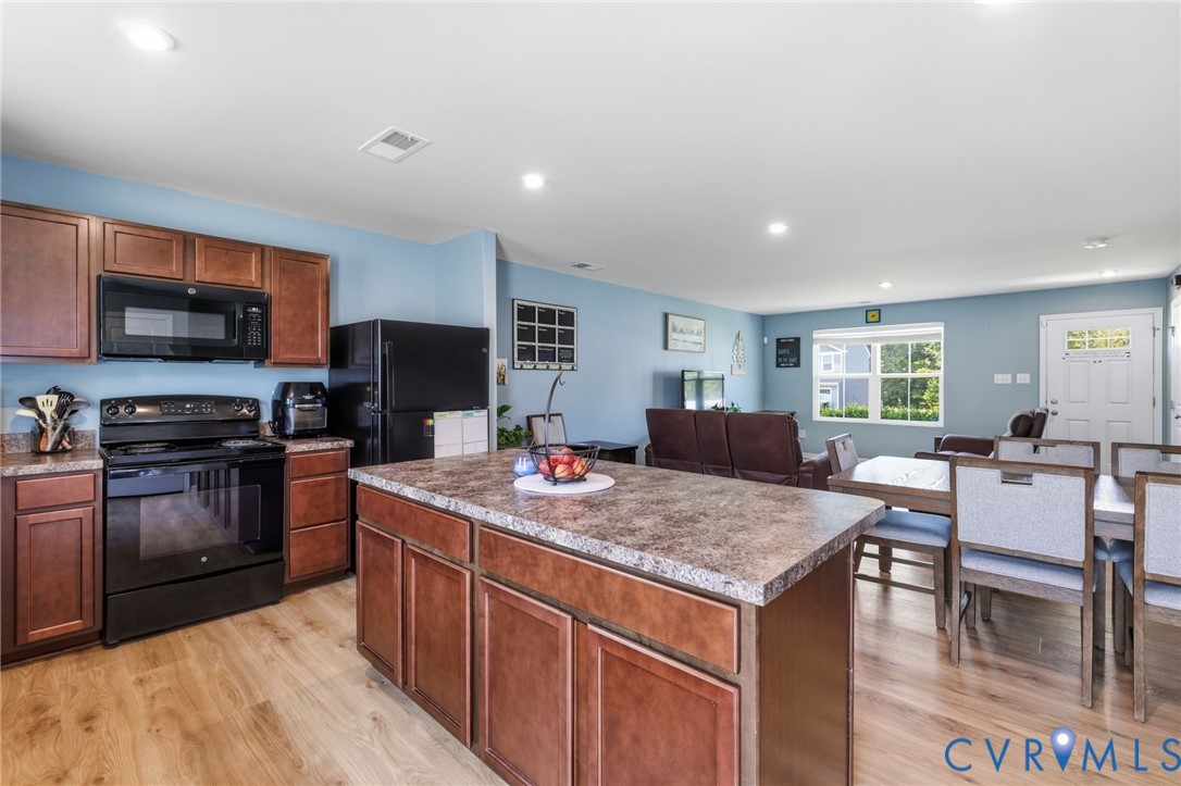 6801 Oakfork Loop New Kent, VA 23124 - Photo 6 of 28 Open-concept living space with wood-finish floorin