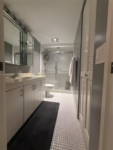 a bathroom with a double vanity sink toilet and shower