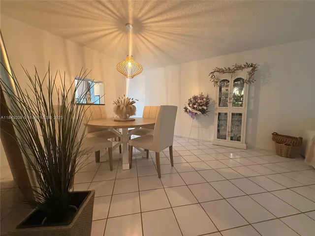 a dining room with furniture and a chandelier