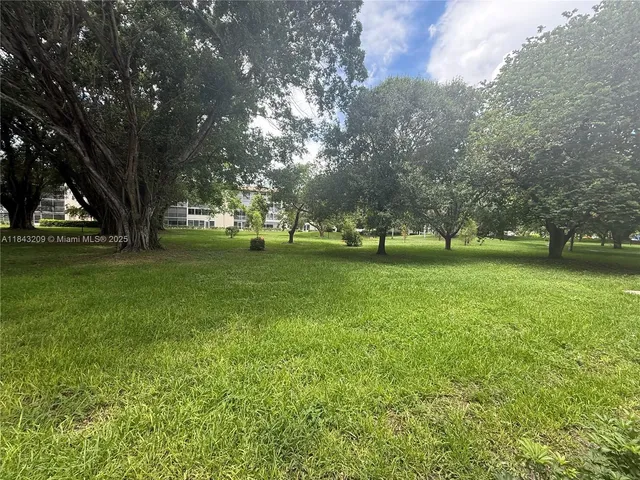 a kitchen with granite countertop a refrigerator and a stove top oven