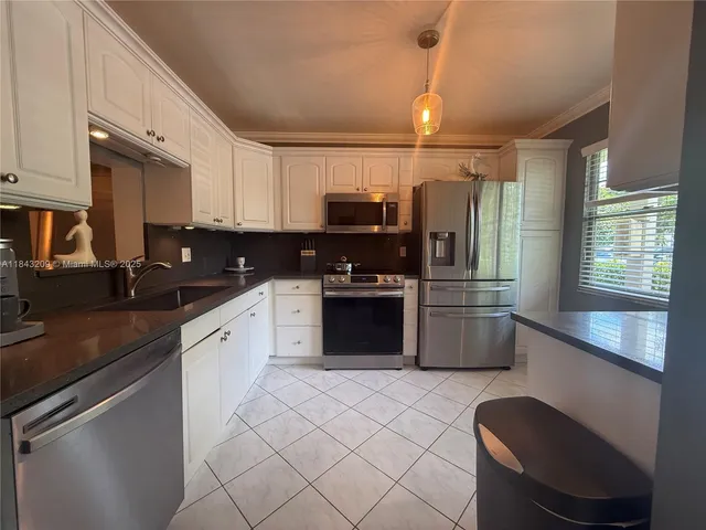 a kitchen with a sink and a refrigerator