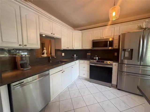 a kitchen with granite countertop a rug stove and a shower