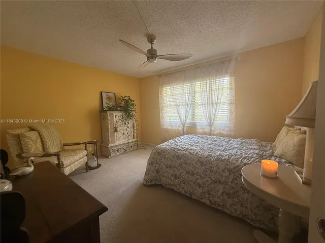 a bedroom with a bed and a television