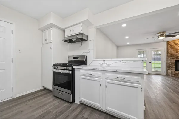 a kitchen with stainless steel appliances granite countertop a stove and a refrigerator