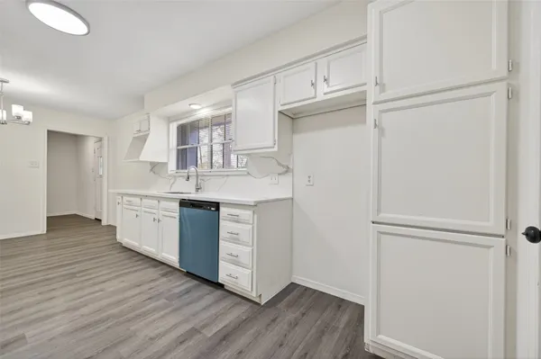 a kitchen with a refrigerator sink and cabinets