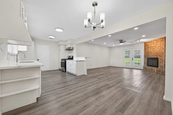 a view of a kitchen with a sink and wooden floor