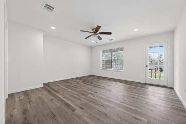 wooden floor in an empty room with a window