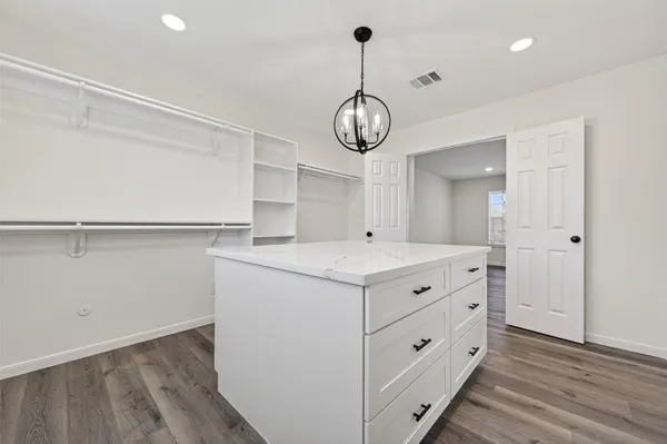 a kitchen with a cabinets and wooden floor
