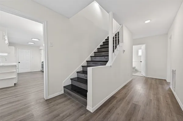 a view of entryway and hall with wooden floor
