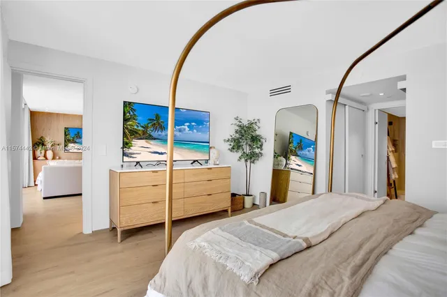 a bedroom with a bed and a mirror