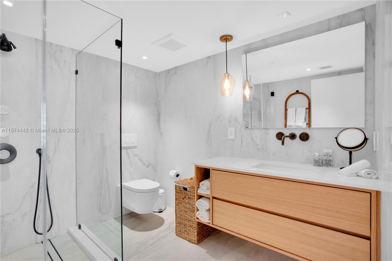 9195 Collins Avenue, Unit 903 Surfside, FL 33154 - Photo 27 of 51 a bathroom with a sink and a mirror