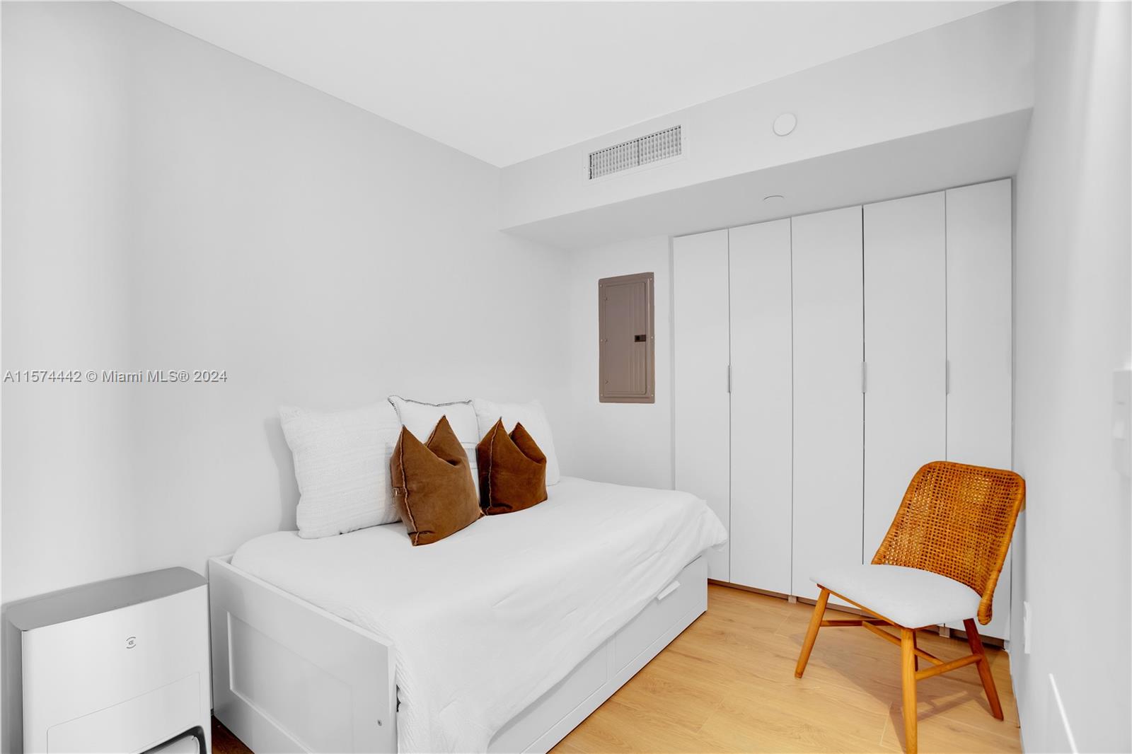 9195 Collins Avenue, Unit 903 Surfside, FL 33154 - Photo 28 of 51 a bedroom with a bed and chair