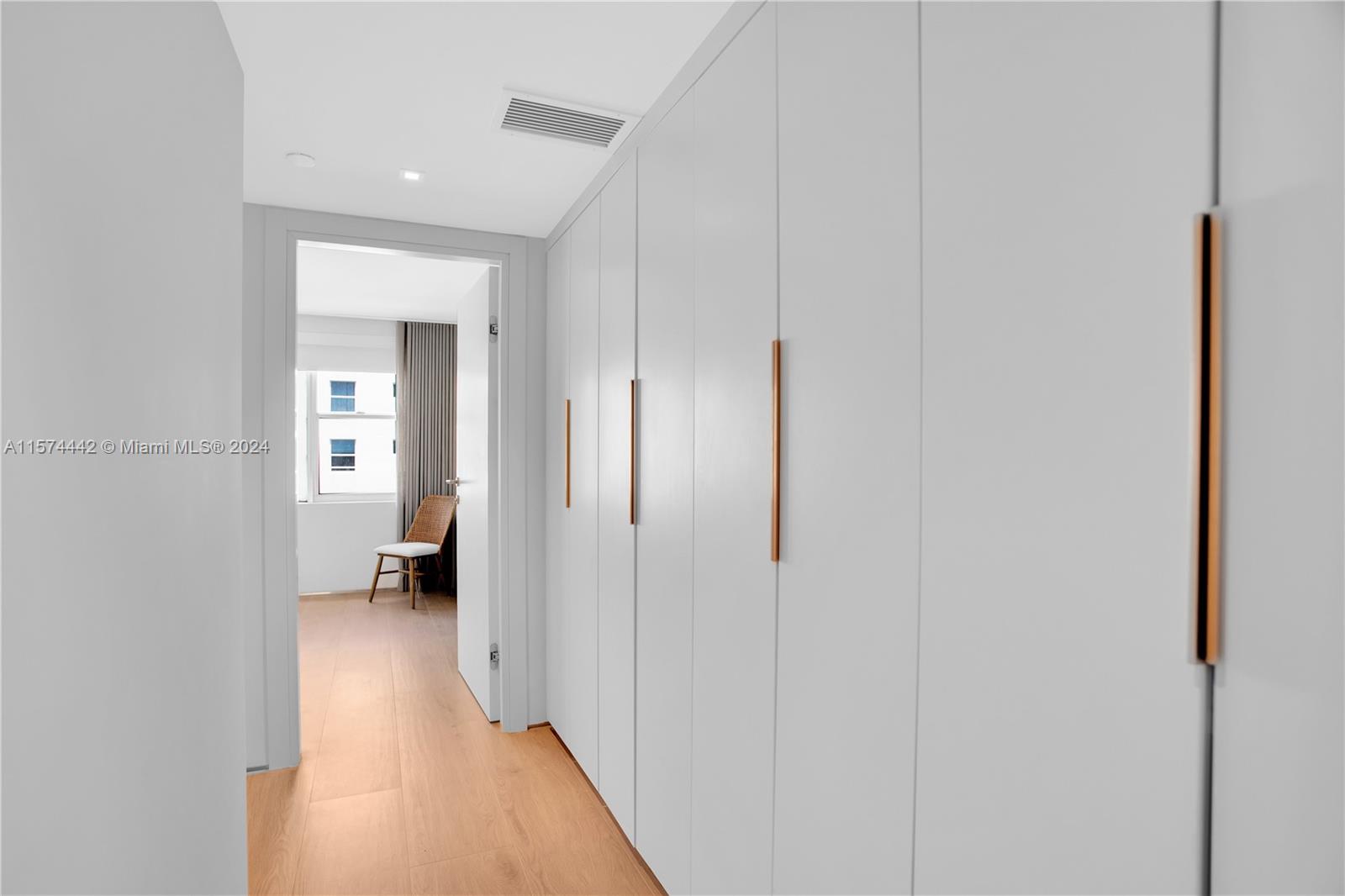 9195 Collins Avenue, Unit 903 Surfside, FL 33154 - Photo 31 of 51 a view of a hallway with a view of bedroom and chair