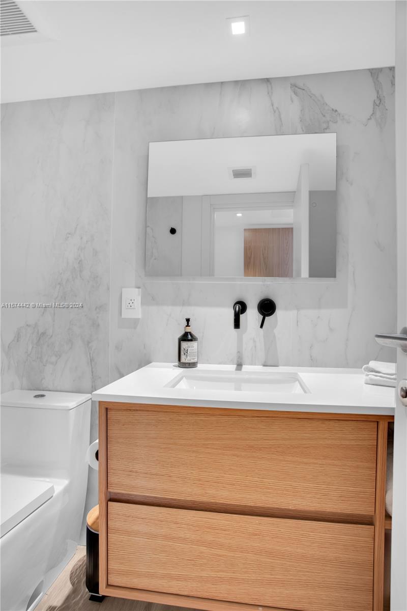 9195 Collins Avenue, Unit 903 Surfside, FL 33154 - Photo 38 of 51 a bathroom with a sink and a bathtub