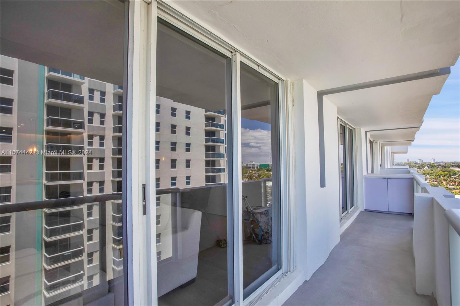 9195 Collins Avenue, Unit 903 Surfside, FL 33154 - Photo 42 of 51 a view of hallway with walk in closet and wooden floor