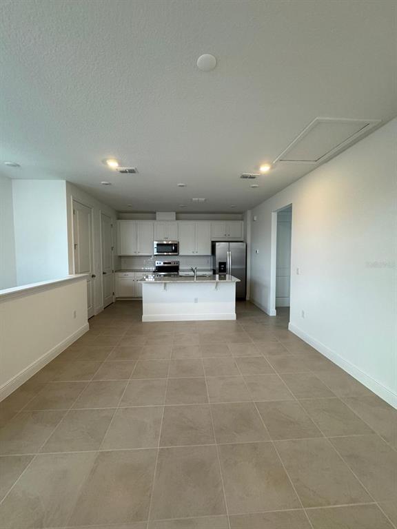 10070 Fiddley Alley Orlando, FL 32827 - Photo 6 of 10 a view of a storage & utility room with washer and dryer