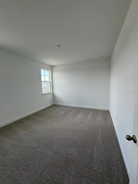 10070 Fiddley Alley Orlando, FL 32827 - Photo 8 of 10 an empty room with windows