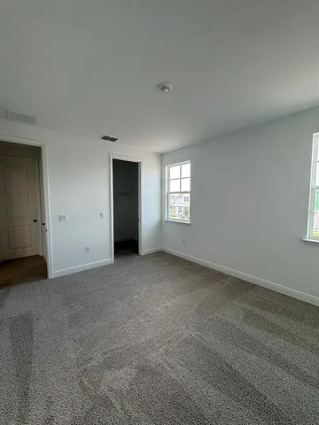 a view of an empty room with windows