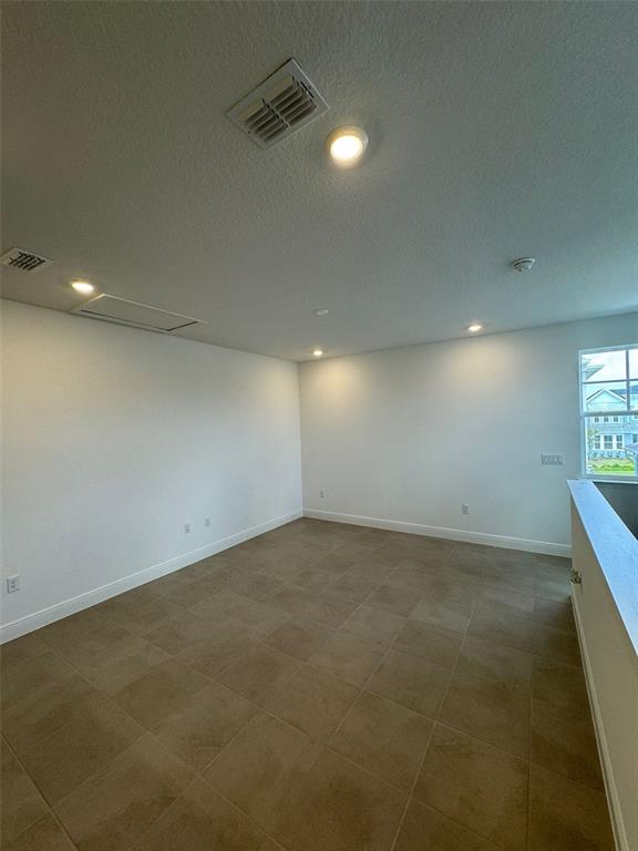 10070 Fiddley Alley Orlando, FL 32827 - Photo 10 of 10 an empty room with windows