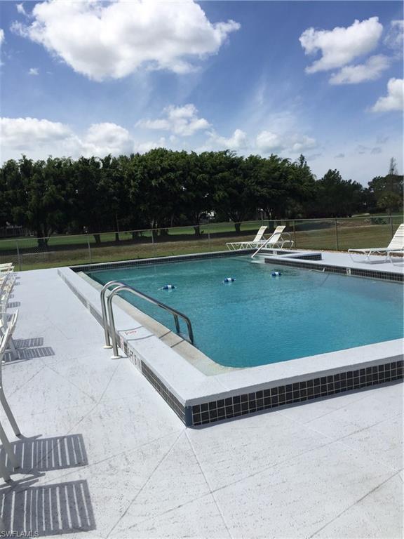 5651 Rattlesnake Hammock Road, Unit C108 Naples, FL 34113 - Photo 5 of 14 a view of swimming pool with a yard