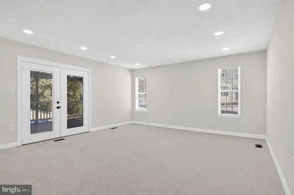 a view of an empty room with glass door