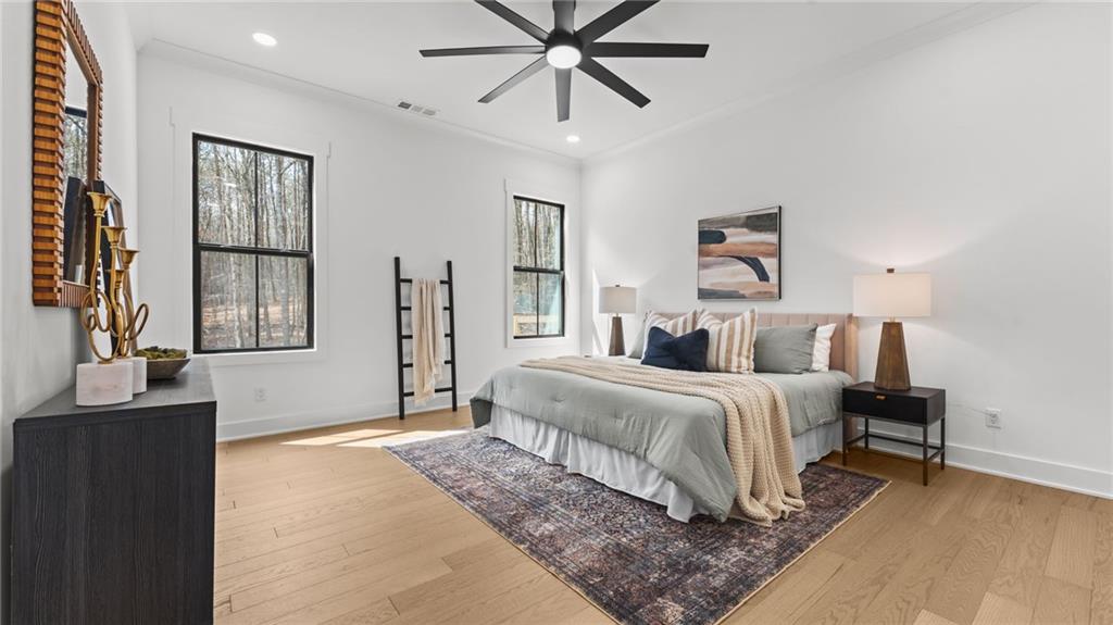 165 Highlands Chase Ball Ground, GA 30107 - Photo 14 of 40 a bedroom with a bed and a chandelier