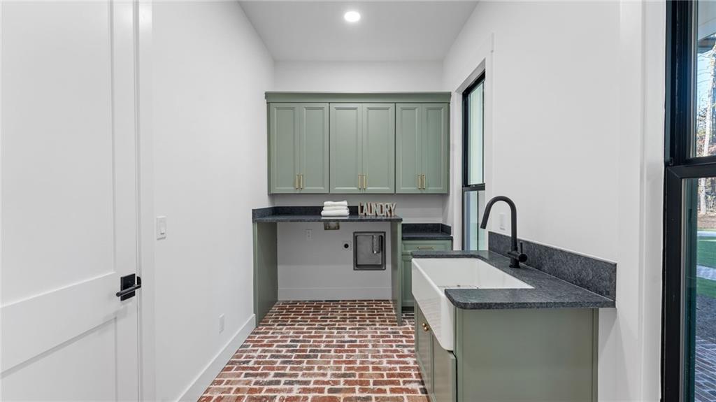 165 Highlands Chase Ball Ground, GA 30107 - Photo 19 of 40 a kitchen with a sink and cabinets