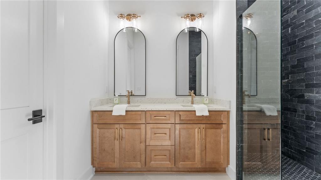 165 Highlands Chase Ball Ground, GA 30107 - Photo 25 of 40 a bathroom with double vanity sinks and a mirror