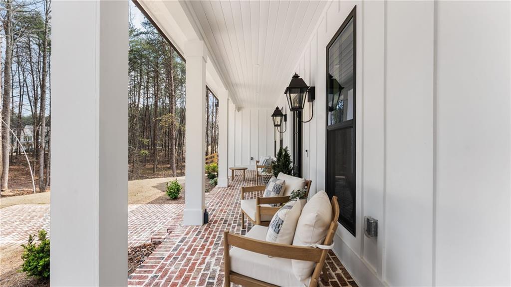 165 Highlands Chase Ball Ground, GA 30107 - Photo 4 of 40 a living room with furniture and a floor to ceiling window