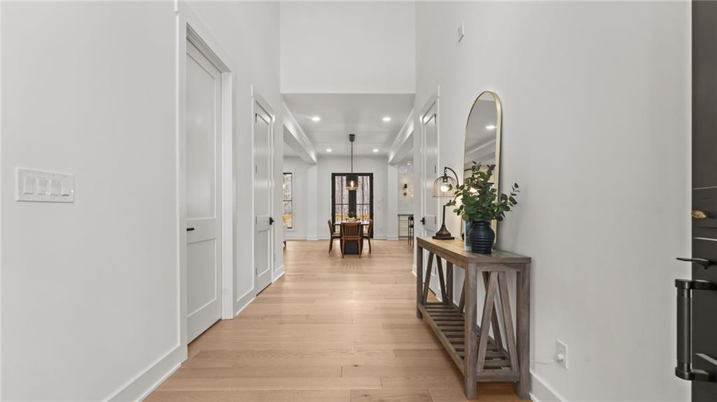 165 Highlands Chase Ball Ground, GA 30107 - Photo 5 of 40 a view of a hallway with wooden floor and a dining room