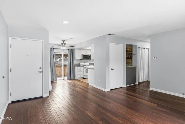 a view of a kitchen with wooden floor and a refrigerator