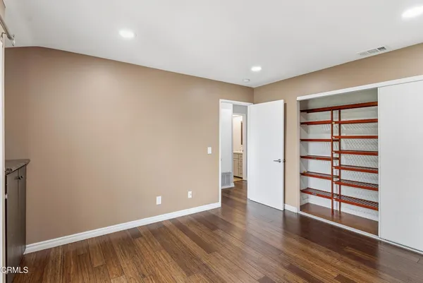 a view of a room with wooden floor and window