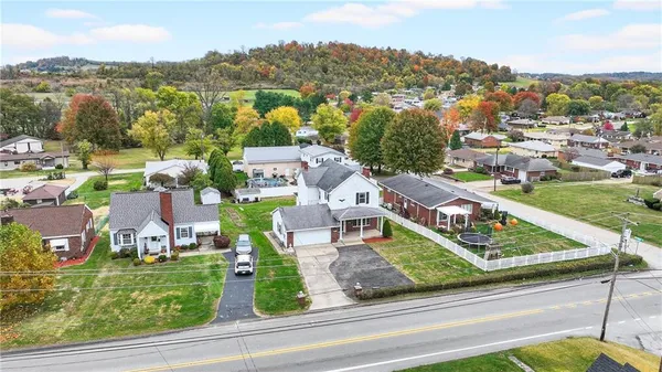 an aerial view of residential houses with outdoor space and river