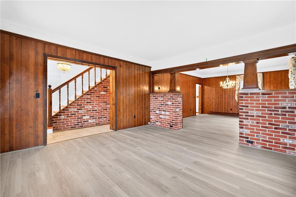 815 Washington Road Belle Vernon, PA 15012 - Photo 15 of 50 a view of an empty room with wooden floor and stairs