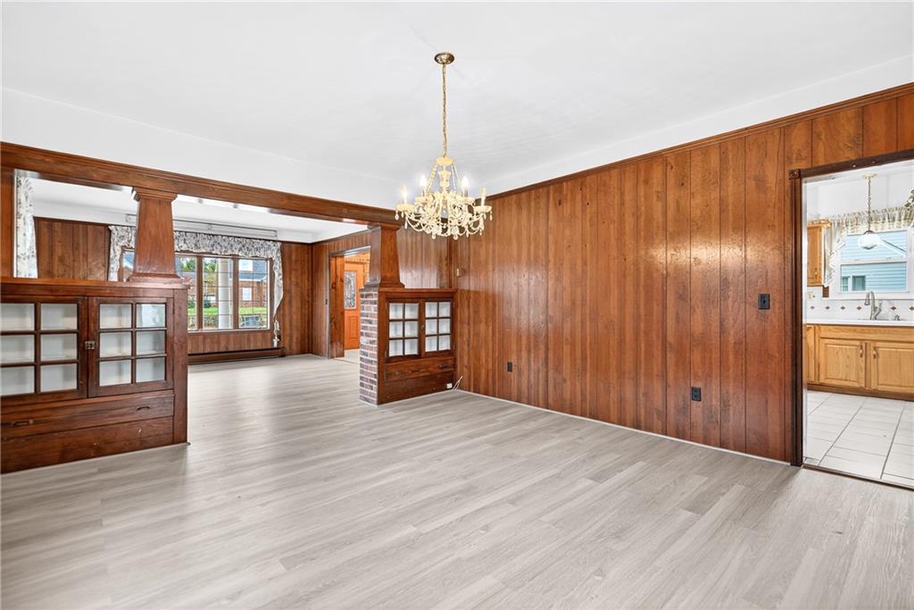 815 Washington Road Belle Vernon, PA 15012 - Photo 19 of 50 a view of an empty room with wooden floor and a kitchen