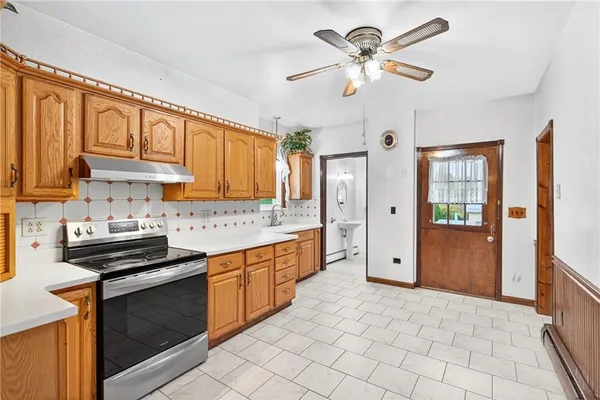 a kitchen with stainless steel appliances granite countertop a stove cabinets and refrigerator