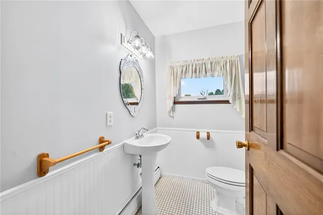 a bathroom with a sink mirror vanity and toilet