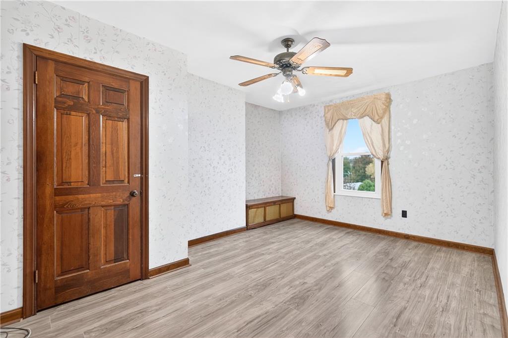 815 Washington Road Belle Vernon, PA 15012 - Photo 30 of 50 an empty room with wooden floor fan and windows
