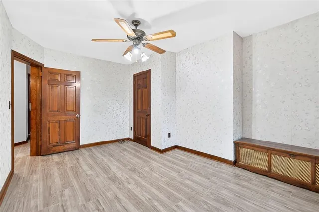 a view of an empty room and wooden floor