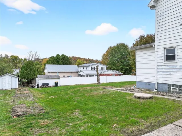 a house view with a sitting space and garden