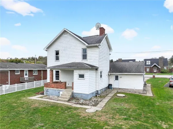 a view of a house with a yard and furniture