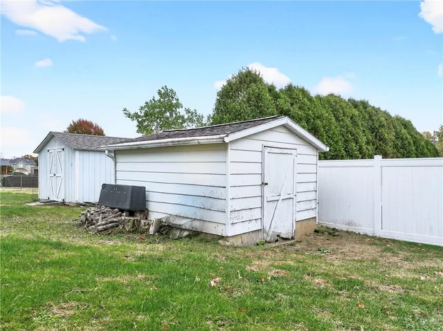 a view of a backyard with chair and garden