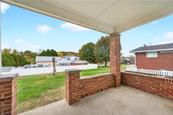 a view of a porch with furniture and garden