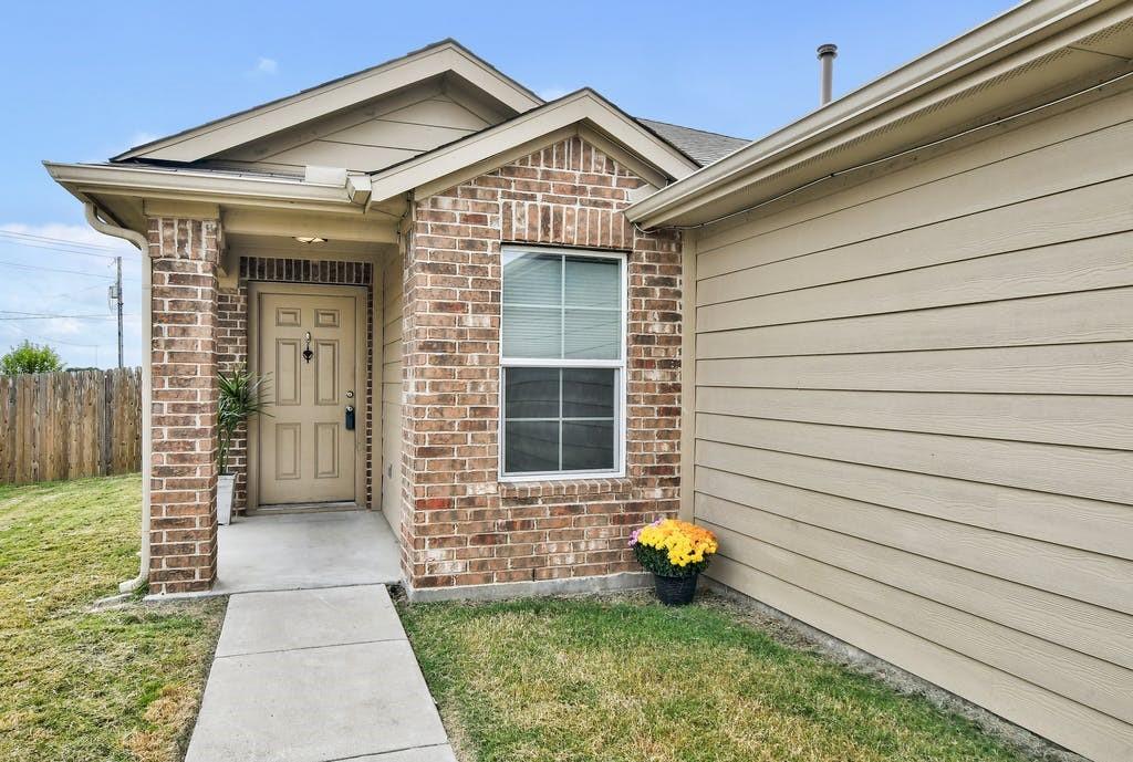Doorway to property with brick siding