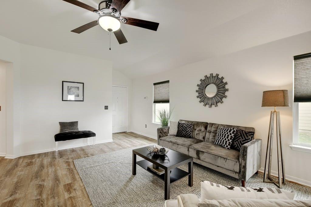 173 Rafe Court Kyle, TX 78640 - Photo 11 of 27 Living area with light wood-style flooring, ceiling fan, and lofted ceiling