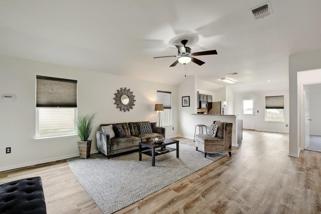 173 Rafe Court Kyle, TX 78640 - Photo 12 of 27 Living room featuring light wood-style flooring, a ceiling fan, and lofted ceiling