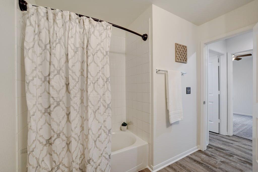 173 Rafe Court Kyle, TX 78640 - Photo 18 of 27 Full bath with shower / tub combo and wood finished floors