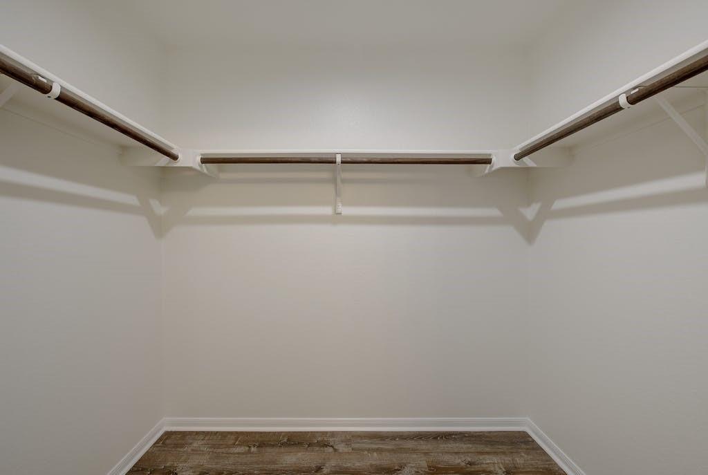 173 Rafe Court Kyle, TX 78640 - Photo 22 of 27 Walk in closet with dark wood-style flooring