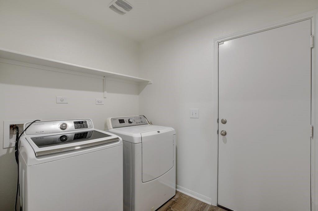 173 Rafe Court Kyle, TX 78640 - Photo 23 of 27 Laundry area featuring washing machine and clothes dryer and light wood finished floors